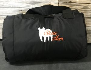 Black duffel bag embroidered with "Show Mom